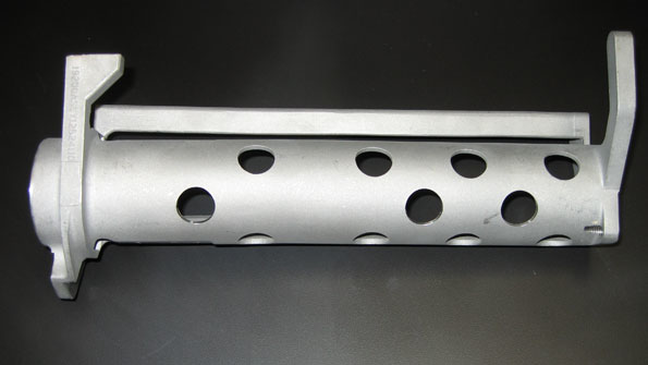 A Mark 38 machine gun ejection chute