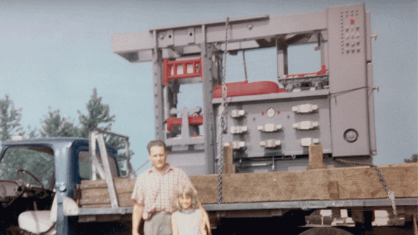 Al Hunter and his daughter commemorate the completion and delivery of the first automated matchplate molding machine in 1963