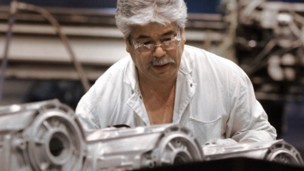A General Motors worker operating a highpressure aluminum diecasting machine producing transmission parts at Bedford IN