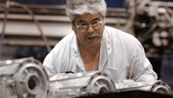 A General Motors worker operating a highpressure aluminum diecasting machine producing transmission parts at Bedford IN A General Motors worker operating a highpressure aluminum diecasting machine producing transmission parts at Bedford IN