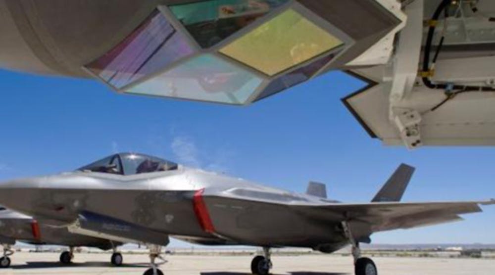 The F-35 Lightning II is a stealth fighter built by Lockheed for the U.S. Air Force, U.S. Marine Corps, U.S. Navy, and the Royal Air Force. The Electro-optical Targeting System (top of the photo, behind a sapphire window) is integrated with the fuselage and provides air-to-air and air-to-surface targeting capability.
