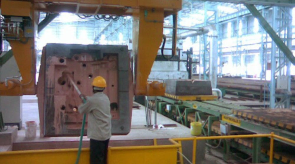 A mold coating process prior to casting.