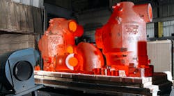 Large-dimension ferrous castings, seen exiting a heat-treating chamber.