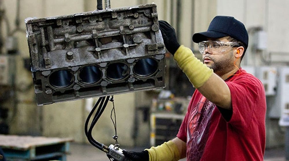 In this 2011 photo, GM Saginaw Metal Casting employee Quentin Wright handles a four-cylinder aluminum block casting. Reports indicate the automaker will add a new casting process to produce powertrain parts. (John F. Martin photo for General Motors)
