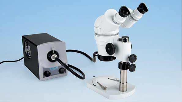Titan Tool Supplyrsquos LuxPro LED fiberoptic light system connected to Titan Tool stereo zoom microscope