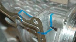 Blue paint outlines the areas of material andor structural vulnerability in an aluminum casting Blue paint outlines the areas of material andor structural vulnerability in an aluminum casting