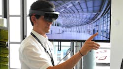 An ldquoaugmented realityrdquo developer at AMRCrsquos Integrated Manufacturing Group positions a holographic image of a robot with his finger using Microsoftrsquos HoloLens technology An ldquoaugmented realityrdquo developer at AMRCrsquos Integrated Manufacturing Group positions a holographic image of a robot with his finger using Microsoftrsquos HoloLens technology