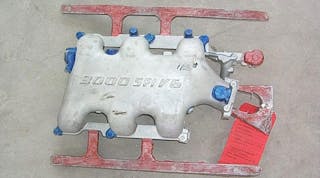 Once the coating procedure for a casting is determined, it must be recorded for future reference. One method is to mark a sample casting with paint. Here, unpainted areas have a standard coating, the blue areas are trimmed and coated with graphite coating, and red painted runners and risers are coated with isolative coating.