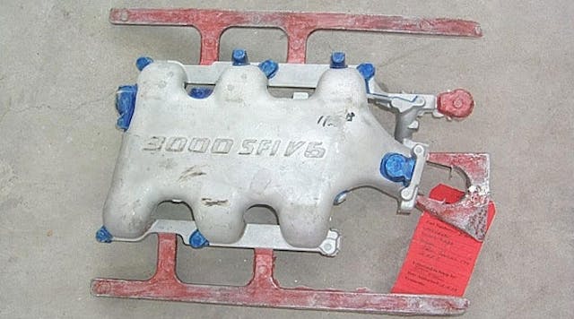 Once the coating procedure for a casting is determined, it must be recorded for future reference. One method is to mark a sample casting with paint. Here, unpainted areas have a standard coating, the blue areas are trimmed and coated with graphite coating, and red painted runners and risers are coated with isolative coating.