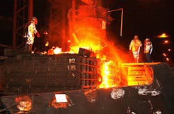 Iron foundry workers pouring Iron foundry workers pouring