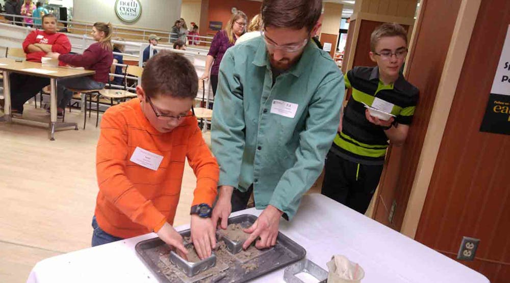 Josh Dorn and a future foundryman from a Houghton, MI, school pack a mold, as part of a &ldquo;foundry in a box&rdquo; demonstration.