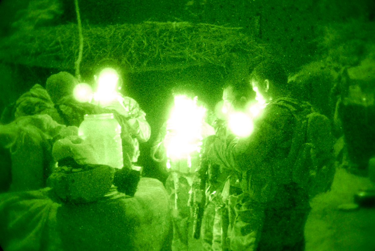 Service members from Special Operations Task Force - South review their maps during the pre-dawn hours of Oct. 30, 2010, in the village of Talukan, Panjwa&rsquo;i District, Afghanistan. A combined force consisting of nearly 100 Afghan Commandos from 4th Commando Kandak, combat advised by a team from SOTF-S, were in the village to rid the area of insurgents, gather intelligence and neutralize any improvised explosive devices.
