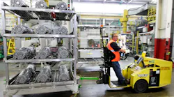A GM worker hauls aluminum castings.at the Bedford, IN, casting plant.