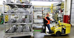 A GM worker hauls aluminum castings.at the Bedford, IN, casting plant. A GM worker hauls aluminum castings.at the Bedford, IN, casting plant.