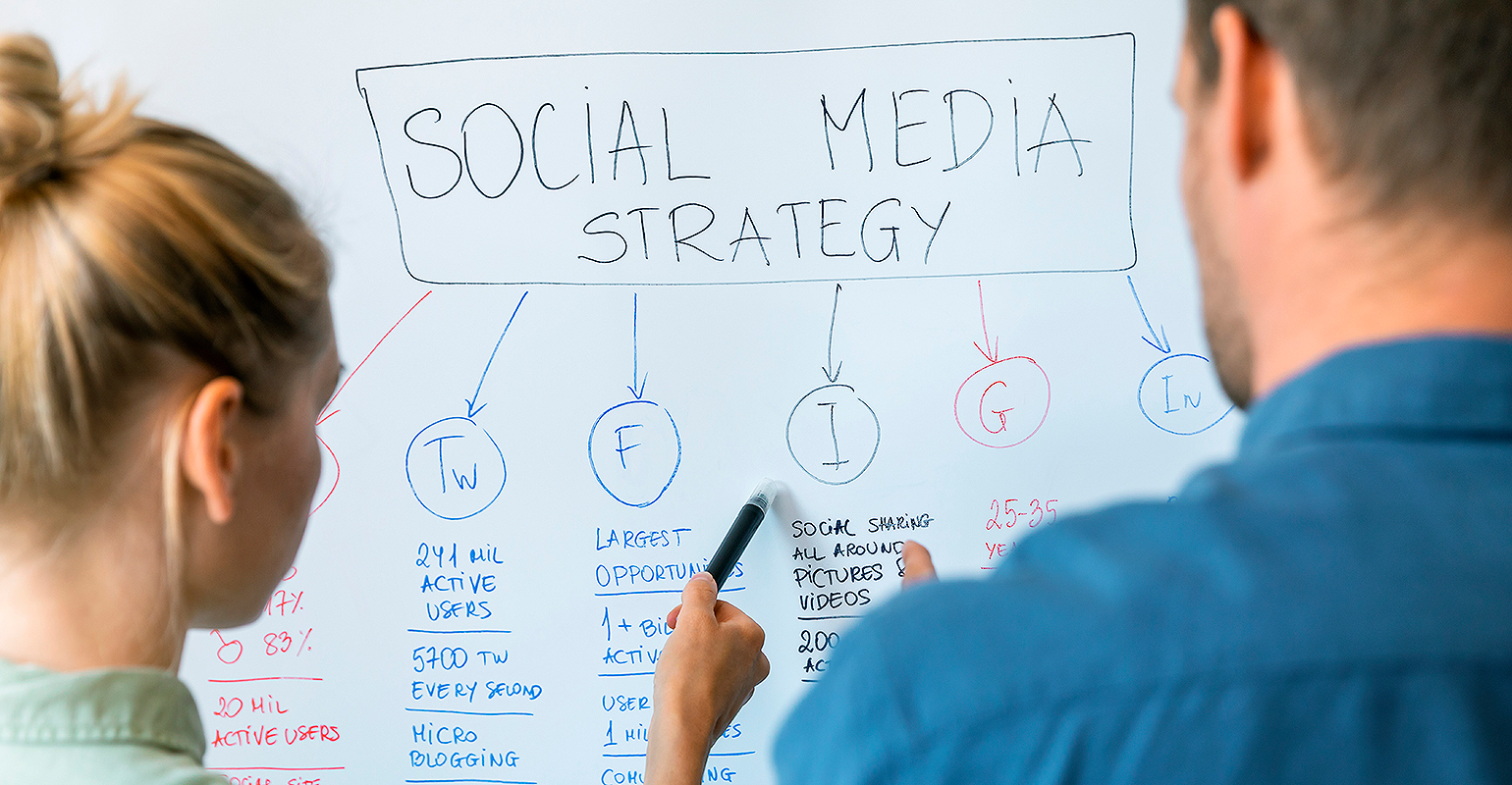 Colleagues work at whiteboard.