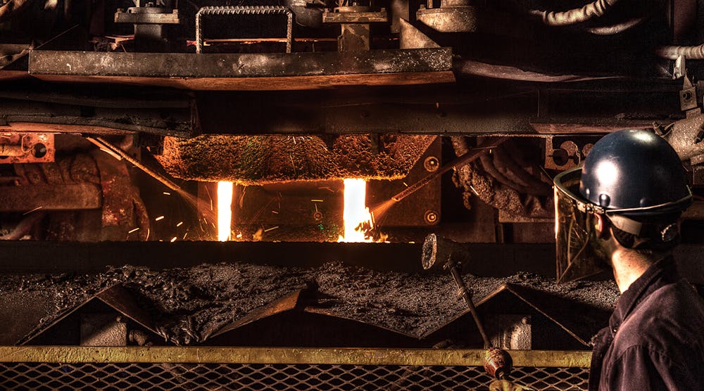 A worker tends a dual stream pouring process at Waupaca Foundry in Etowah, TN.