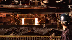 A worker tends a dual stream pouring process at Waupaca Foundry in Etowah, TN.
