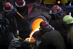 Metalcasters at work together at ladle pouring. Metalcasters at work together at ladle pouring.