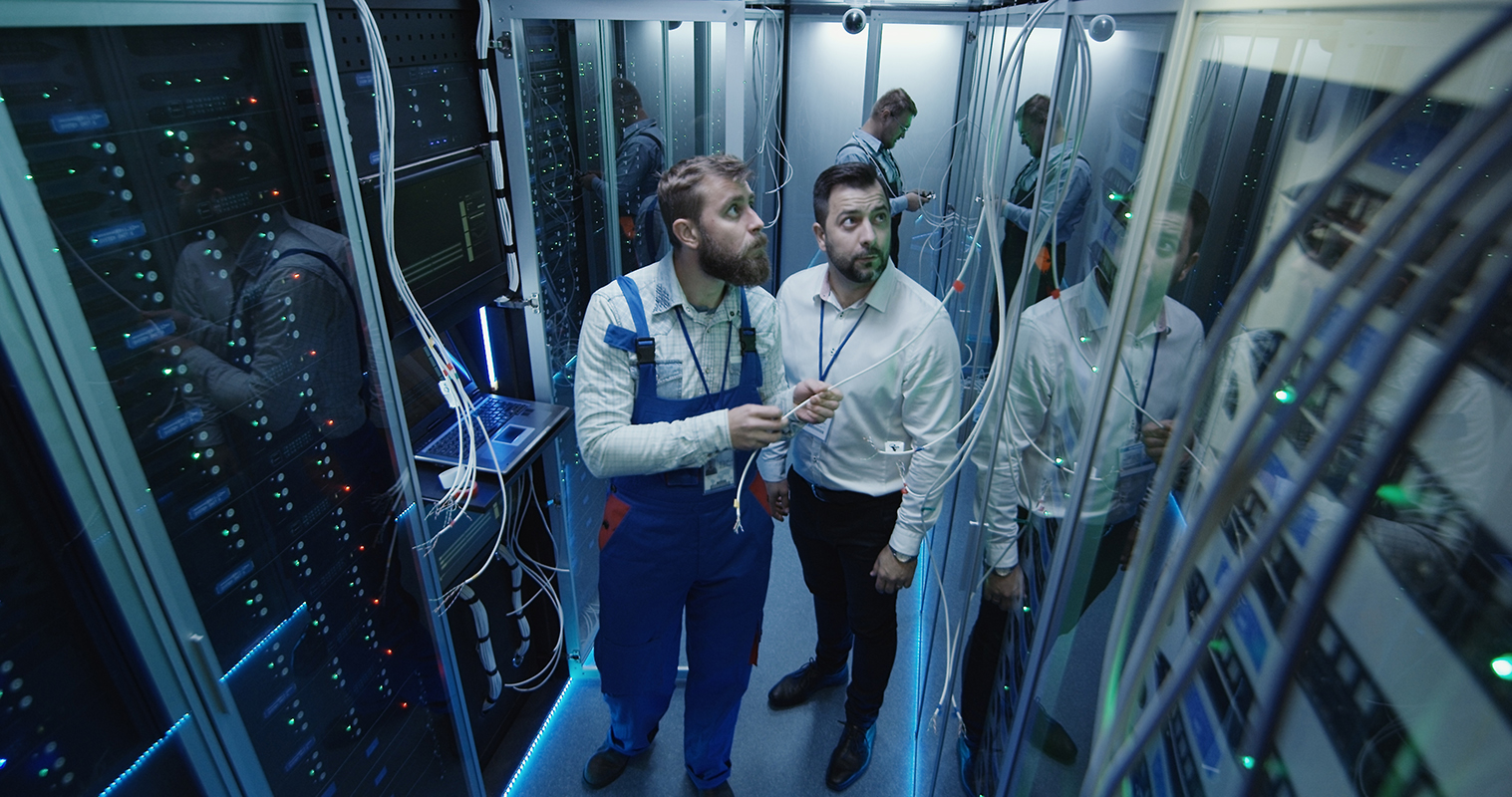 Two techs study Big Data servers.