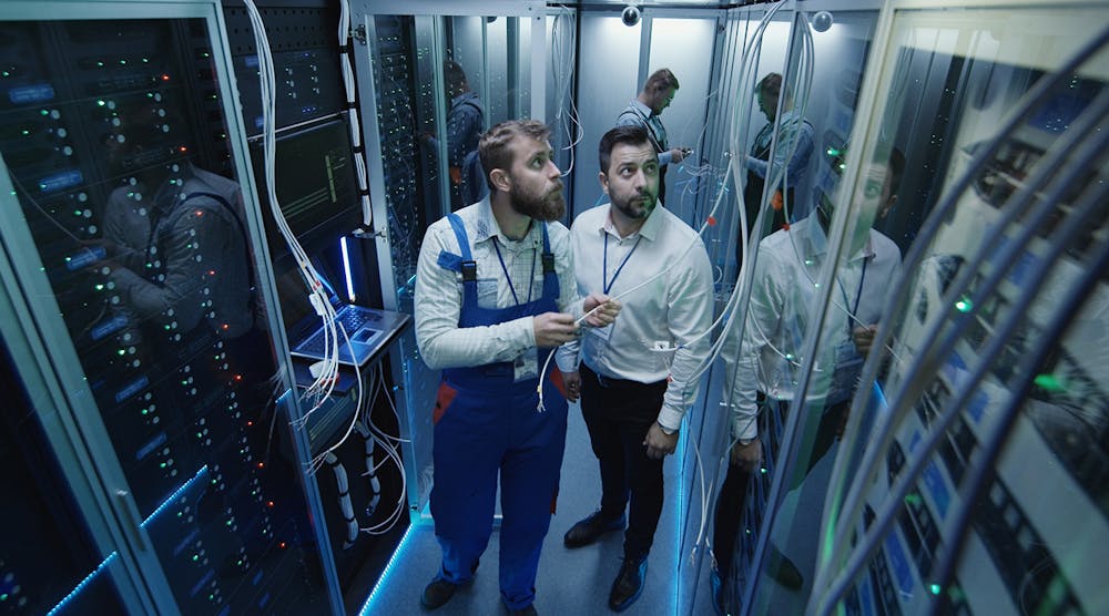Two techs study Big Data servers.