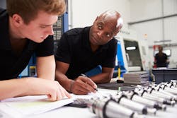 Apprentice and mentor in a workshop. Apprentice and mentor in a workshop.
