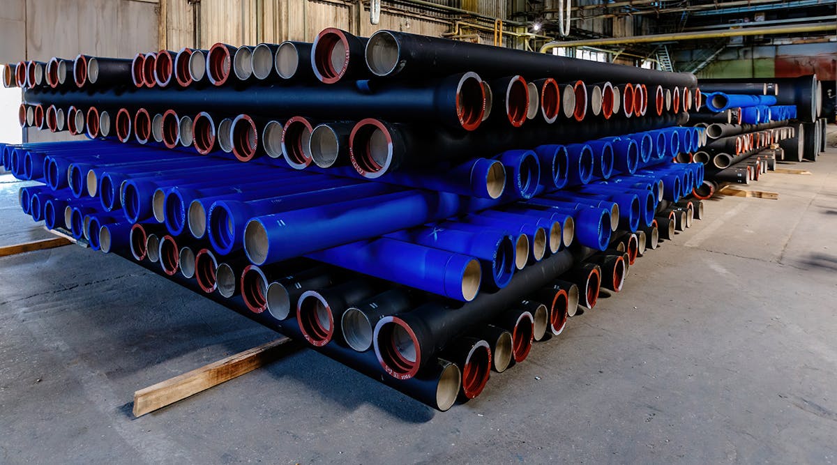Cast iron pipe products on pallets in a warehouse.