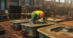 Workers and molds in a metallurgical foundry. Workers and molds in a metallurgical foundry.