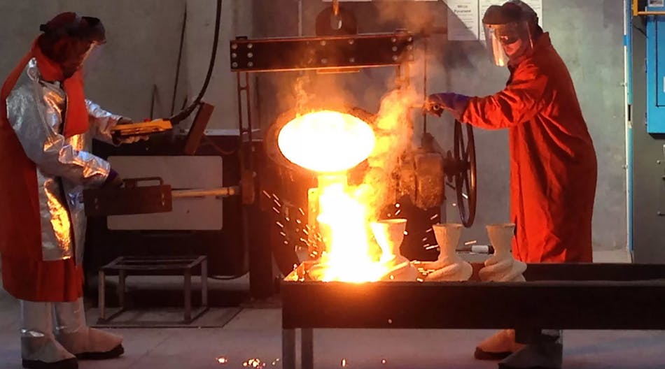 Workers pour molten metal into investment casting molds.
