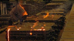 Pouring hot metal into sand molds. Pouring hot metal into sand molds.