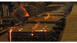 Pouring hot metal into sand molds. Pouring hot metal into sand molds.