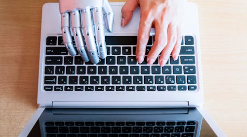 Robot hands and fingers point to laptop button: Artificial Intelligence.
