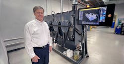 TriTech owner Robert Swenson, shown with the Production System P-1, is a titanium manufacturing expert.