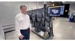 TriTech owner Robert Swenson, shown with the Production System P-1, is a titanium manufacturing expert.