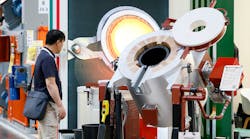 A GIFA 2023 visitor inspects an automated ladle system, Düsseldorf, Germany, June 2023. A GIFA 2023 visitor inspects an automated ladle system, Düsseldorf, Germany, June 2023.