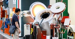 A GIFA 2023 visitor inspects an automated ladle system, Düsseldorf, Germany, June 2023. A GIFA 2023 visitor inspects an automated ladle system, Düsseldorf, Germany, June 2023.