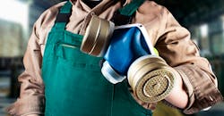 Worker with a respirator. Worker with a respirator.