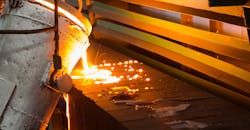 Molten iron pouring into a sand mold. Molten iron pouring into a sand mold.