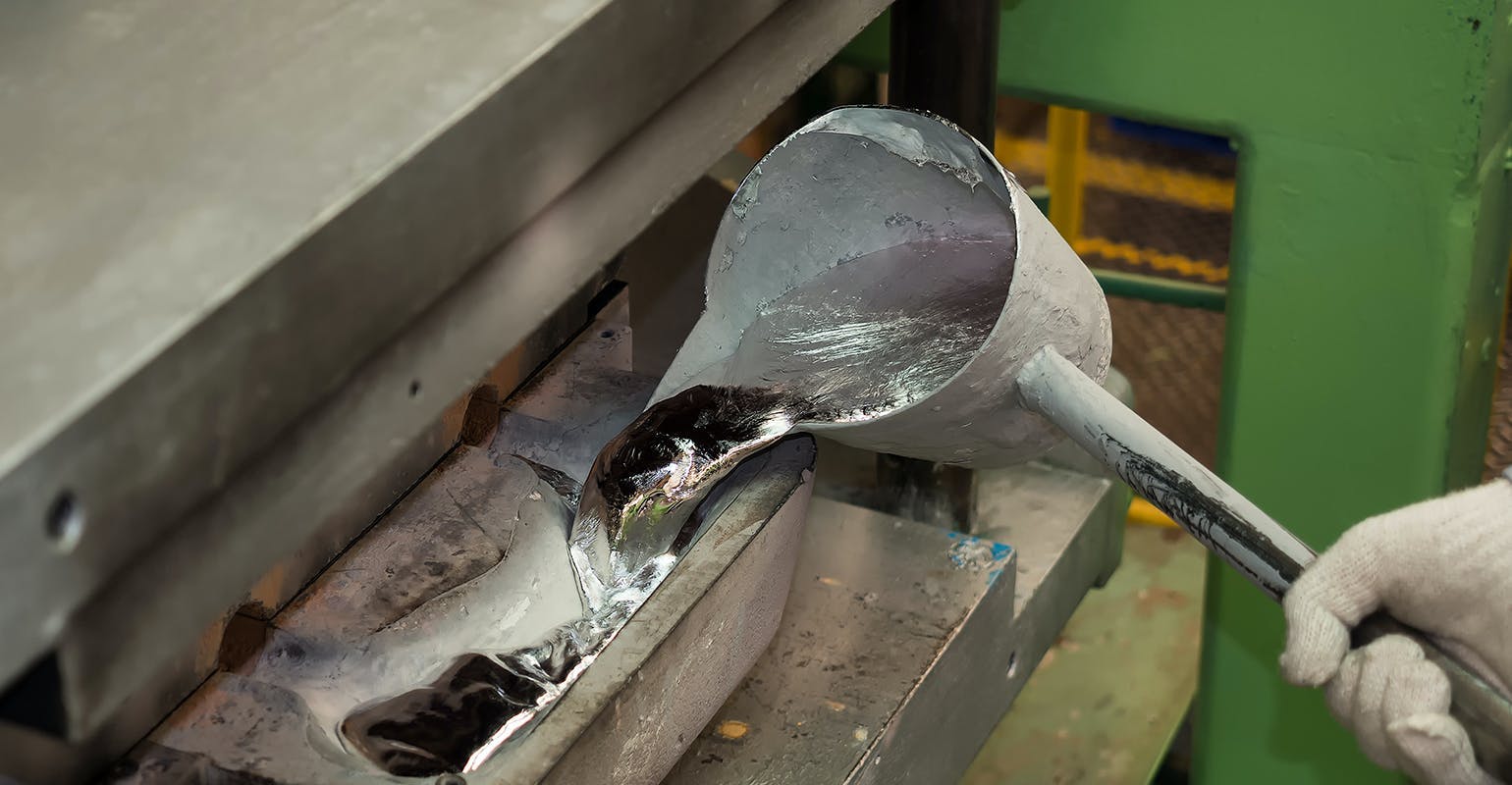 Pouring molten aluminum into a diecasting launder. Oxidation is diminishing the useful value of the alloy whenever the metal is exposed to the atmosphere.