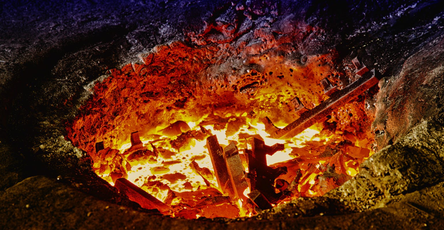 Melting iron in a furnace.