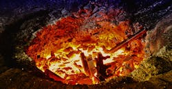 Melting iron in a furnace. Melting iron in a furnace.