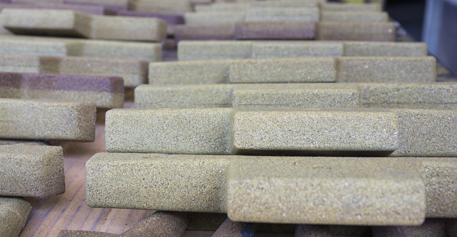 Cores formed in resin-coated sand.