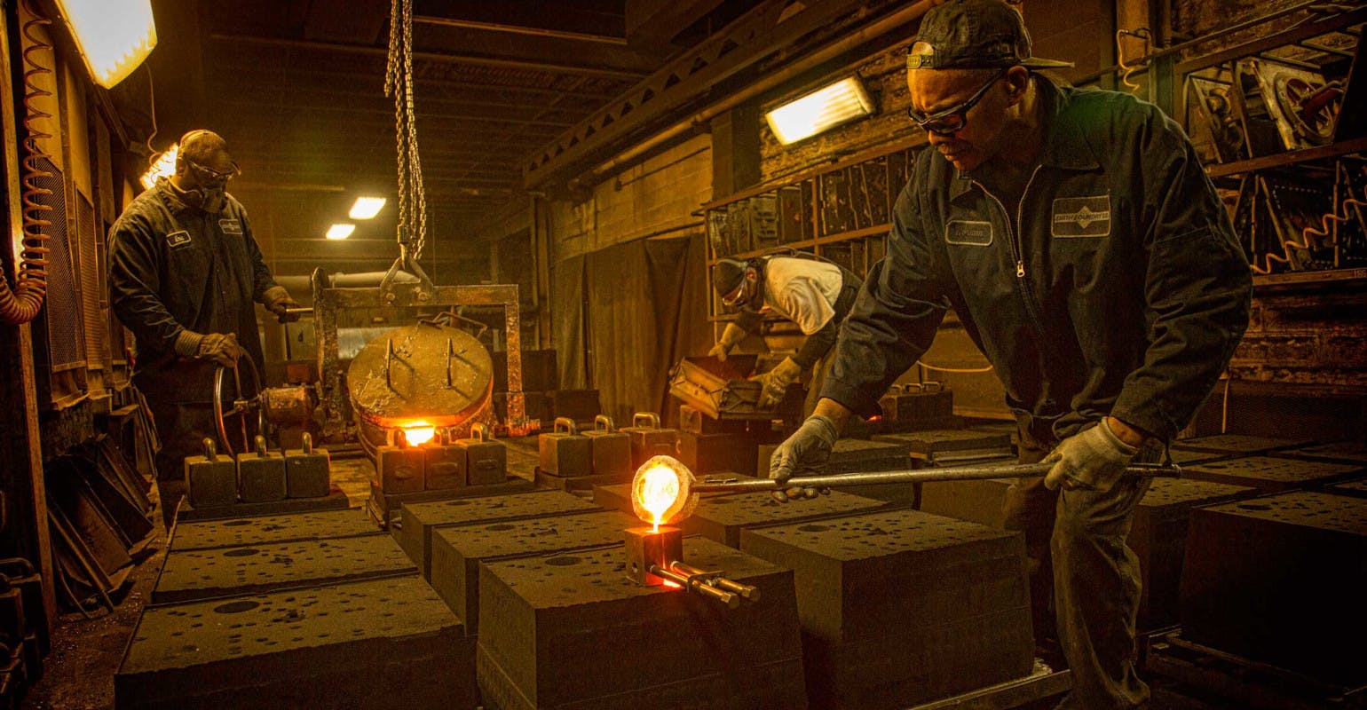 Filling sand molds at Smith Foundry, Minneapolis.