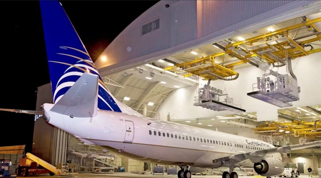 Boeing 737 enters a maintenance hangar.