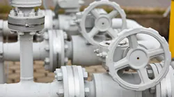 Details of valves and pumps that are part of an industrial gasoline pipeline.