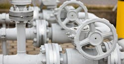 Details of valves and pumps that are part of an industrial gasoline pipeline. Details of valves and pumps that are part of an industrial gasoline pipeline.