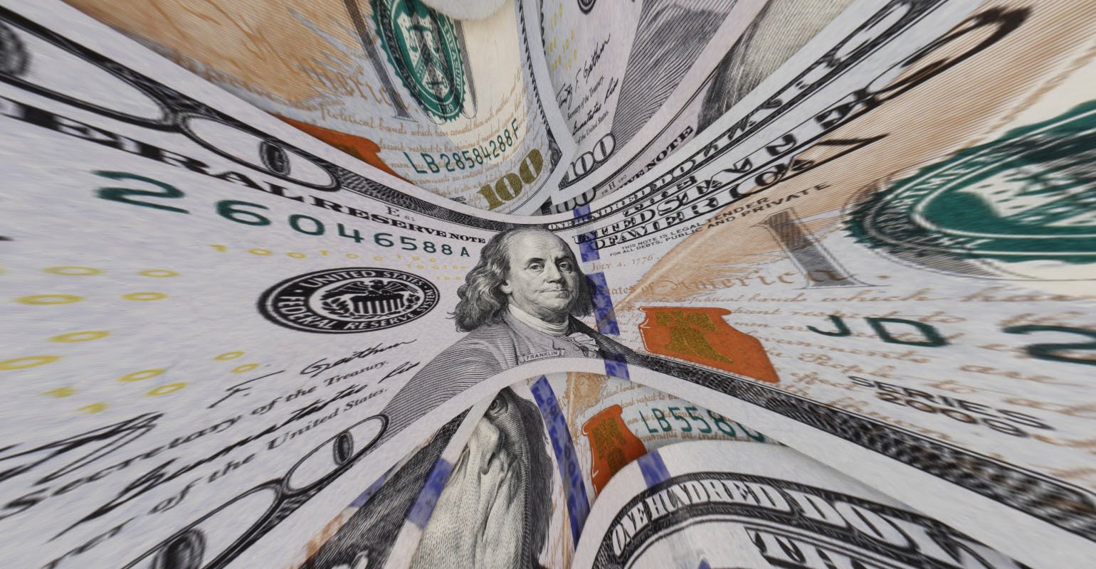 Warped view of a $100 bill, representing high interest rates.