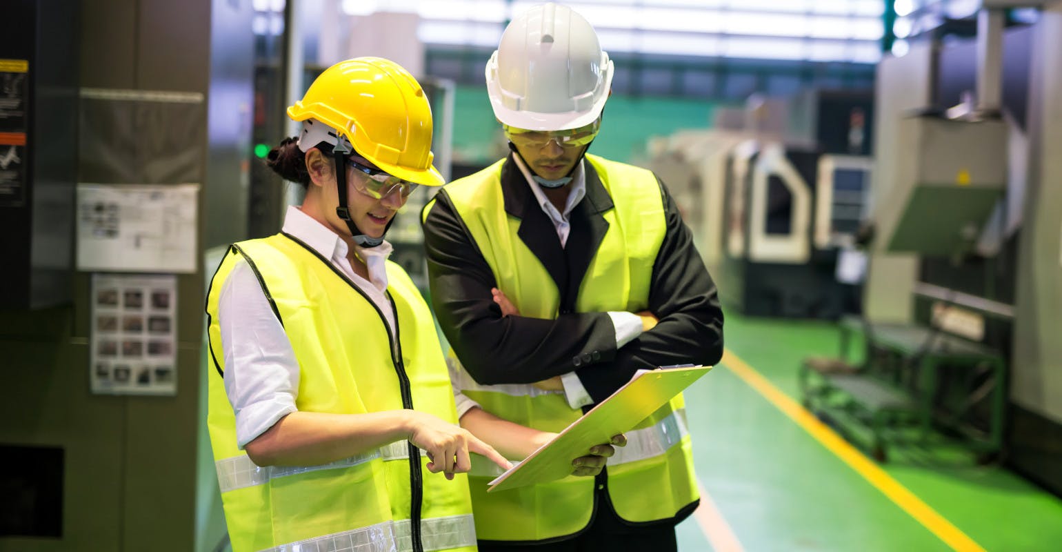 Plant workers review data.