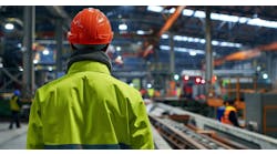 Industrial worker in a factory wearing safety gear. Industrial worker in a factory wearing safety gear.