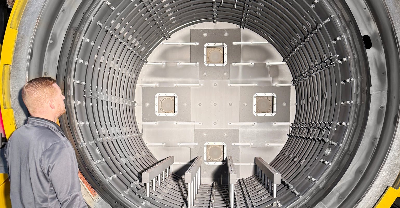 Adam Jones, Midwest regional sales manager at Solar Manufacturing, examines the 48x48x72-inch deep insulated hot zone of a new vacuum furnace at FPM Heat Treating.