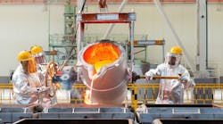 Workers pouring molten metal into sand molds. Workers pouring molten metal into sand molds.